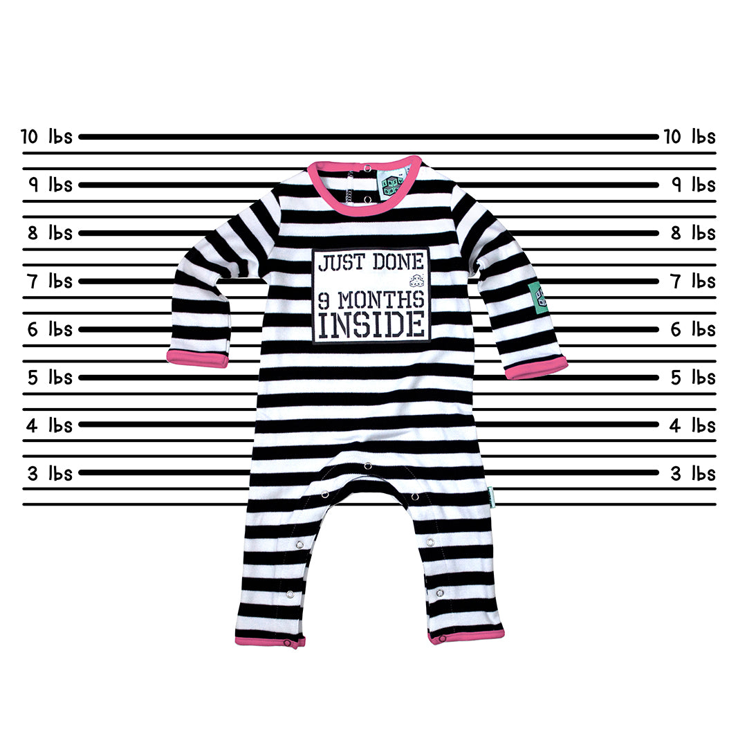 Just Done 9 Months Inside baby grow against a police line up wall