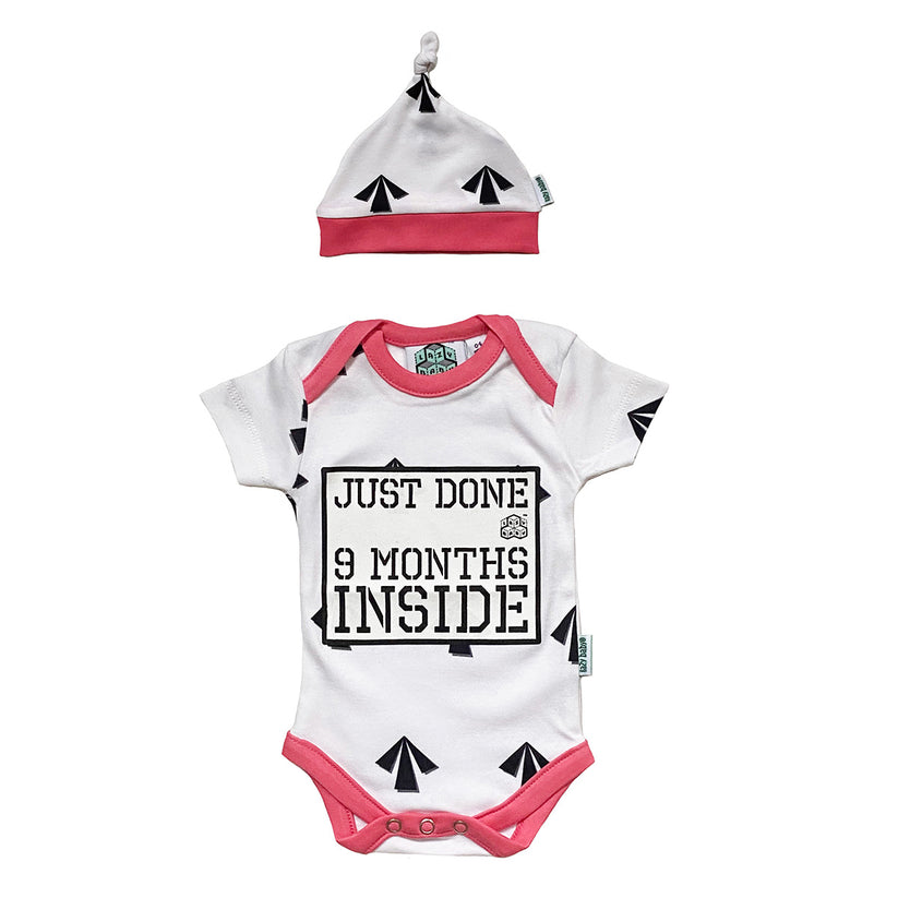 Pink and white vest and hat featuring prison arrows design and Just Done 9 Months Inside slogan